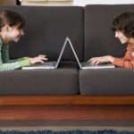 Preteen boy and girl using laptop computers