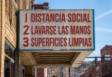 Spanish movie cinema billboard with three rules to avoid the coronavirus epidemic. Translation, wash hands, maintain social distance, clean surfaces